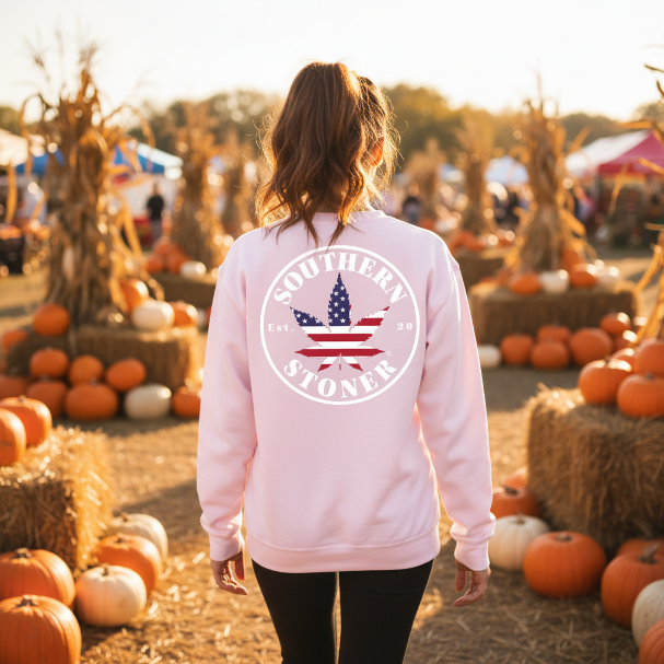 Person wearing a pink sweatshirt with 'Southern Stoner' design at a pumpkin patch.